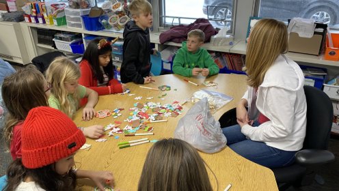 Students collaborating at Elmwood Elementary School with their teacher